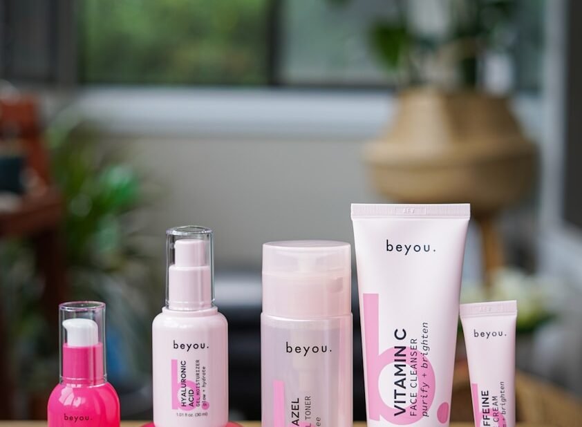 a wooden table topped with lots of beauty products